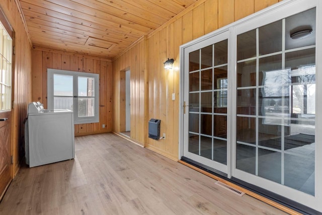 interior space with heating unit, washer / clothes dryer, and wood ceiling