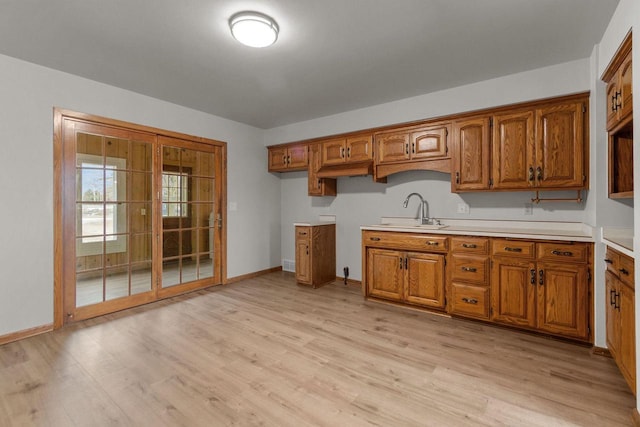 kitchen with light hardwood / wood-style floors and sink