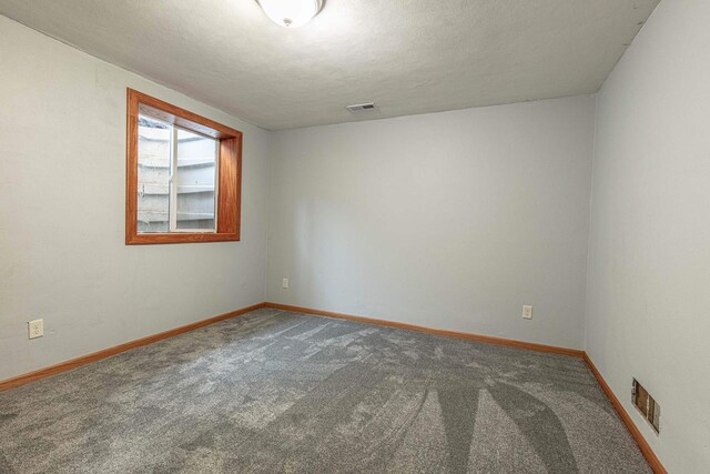 8325 S Avon Store Rd, Brodhead, WI 53520 - unfurnished room with carpet flooring, baseboards, visible vents, and a textured ceiling
