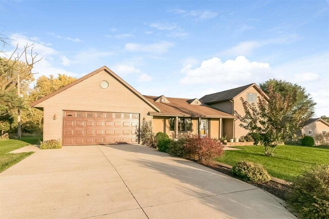 8325 S Avon Store Rd, Brodhead, WI 53520 - view of front of house with a garage, concrete driveway, and a front yard