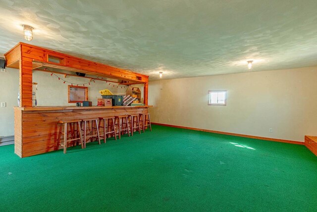 8325 S Avon Store Rd, Brodhead, WI 53520 - basement with carpet flooring, a dry bar, a textured ceiling, and baseboards
