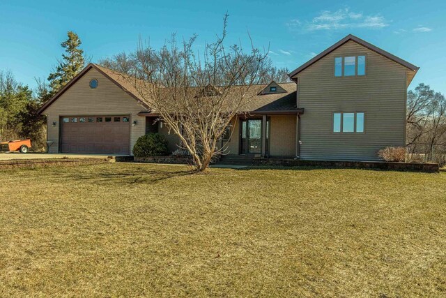 8325 S Avon Store Rd, Brodhead, WI 53520 - view of front of house featuring a garage and a front lawn