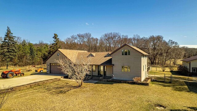 8325 S Avon Store Rd, Brodhead, WI 53520 - view of front of property featuring an attached garage, concrete driveway, a front lawn, and fence