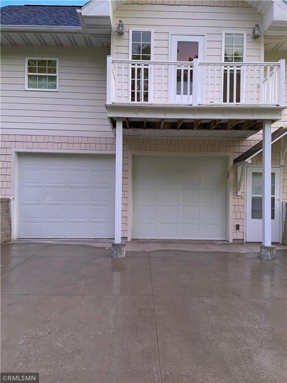 view of front facade with a balcony and a garage