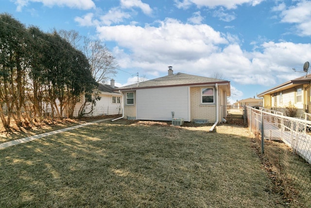 rear view of property with a yard