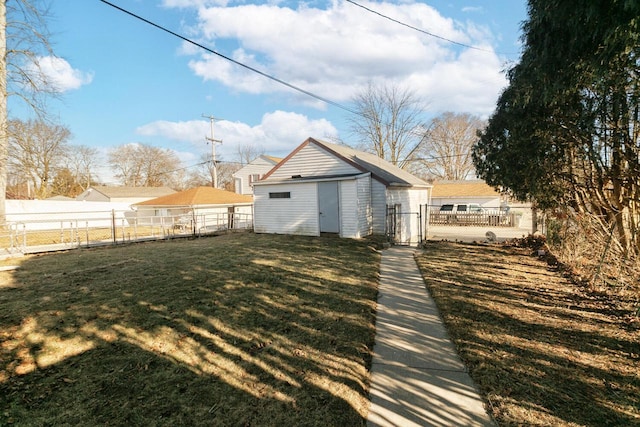 back of property with a yard and an outdoor structure