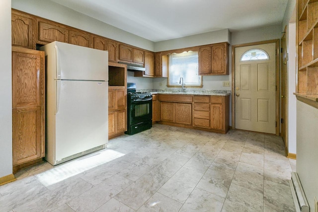 kitchen featuring sink, white refrigerator, and black gas range