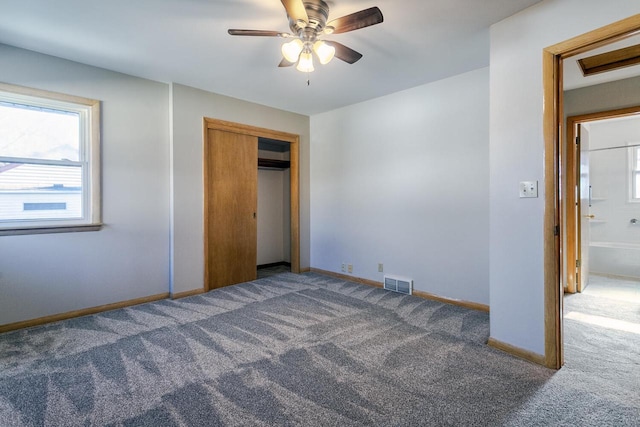 unfurnished bedroom featuring ceiling fan, carpet, and a closet