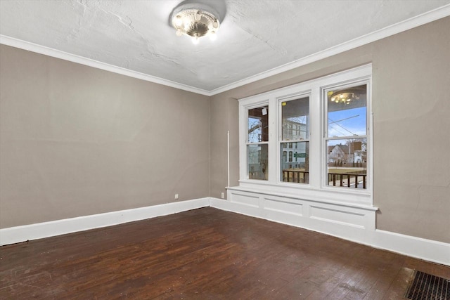 spare room featuring wood-type flooring and ornamental molding