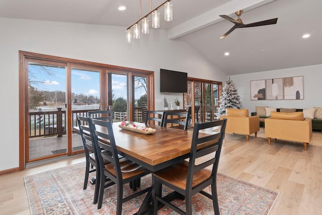 dining space with ceiling fan, light hardwood / wood-style floors, high vaulted ceiling, and beamed ceiling