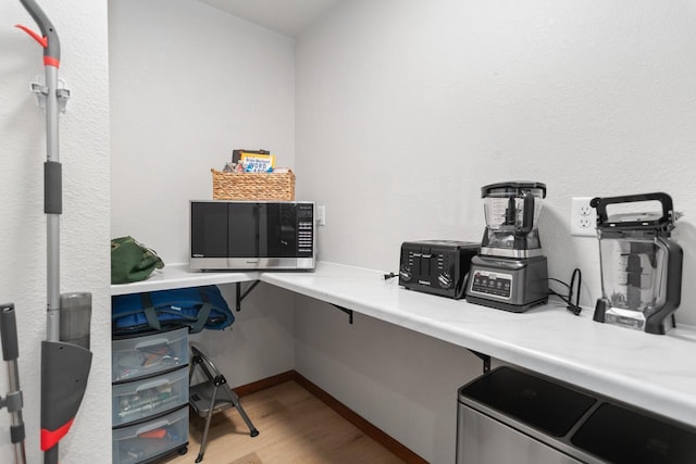 office space featuring built in desk and light wood-type flooring