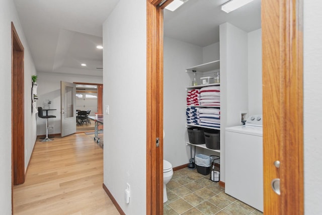 interior space with washer / clothes dryer and light hardwood / wood-style flooring