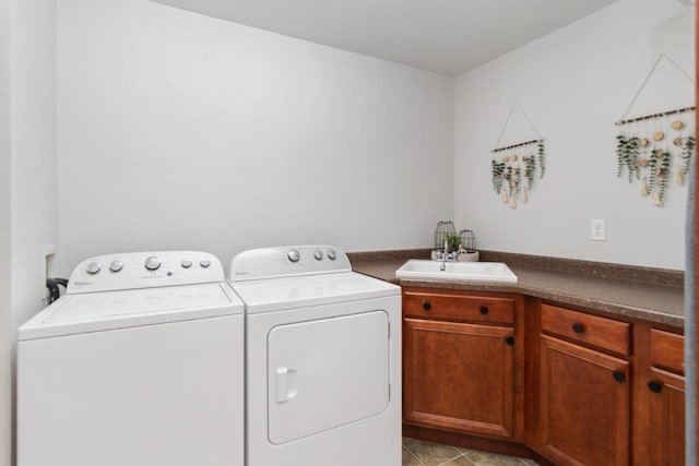 laundry area with washer and clothes dryer, sink, light tile patterned floors, and cabinets