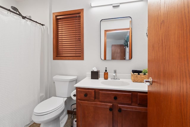 bathroom featuring toilet, vanity, and tile patterned flooring