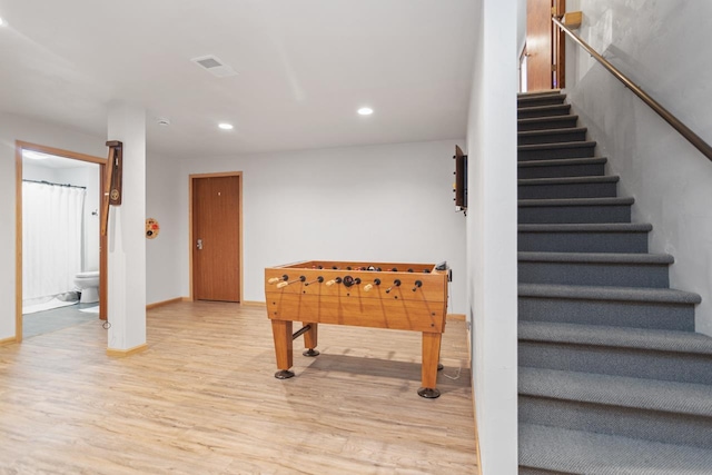 rec room with light hardwood / wood-style flooring