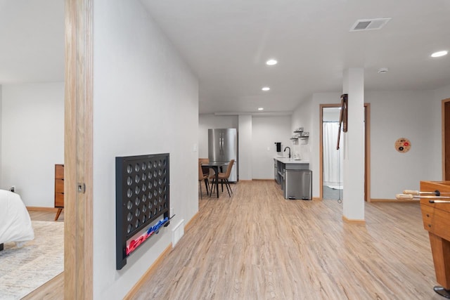 interior space with light wood-type flooring and sink