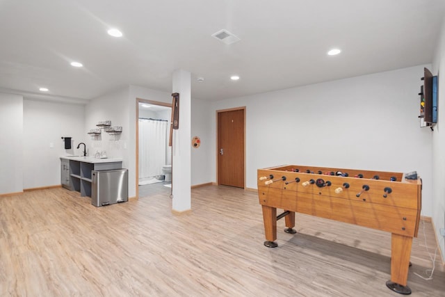 recreation room with light wood-type flooring