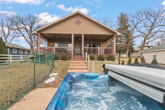 view of front of house with covered porch, a front lawn, and ceiling fan