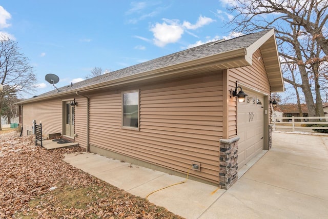 view of side of home featuring a garage