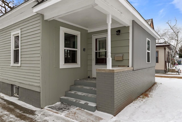 view of snow covered property entrance