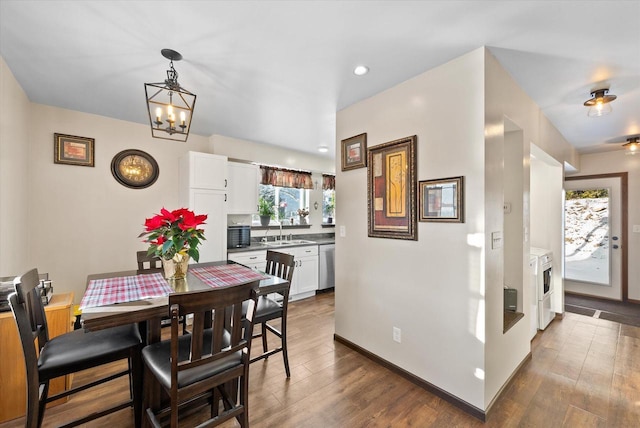 dining room with a chandelier, dark hardwood / wood-style floors, and sink