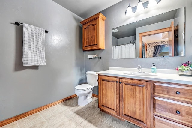 bathroom featuring tile patterned floors, toilet, and vanity