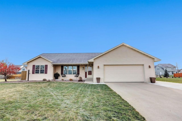 ranch-style home featuring a garage, a front yard, and covered porch