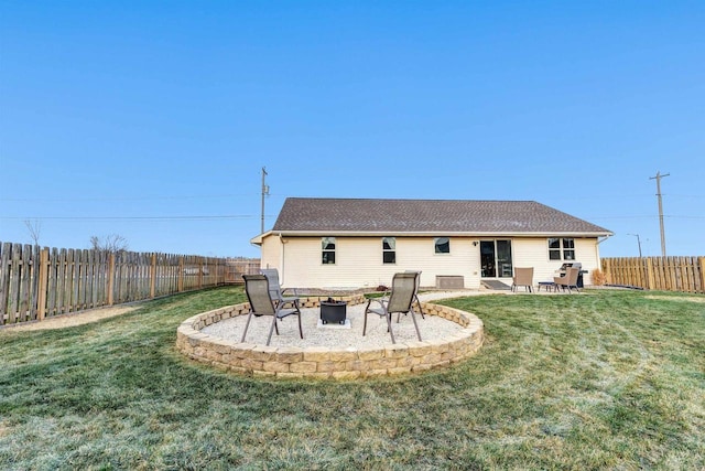 back of property with a lawn, a fire pit, and a patio