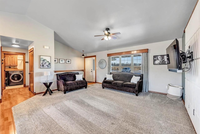 living room featuring ceiling fan, light hardwood / wood-style floors, washer / dryer, and lofted ceiling