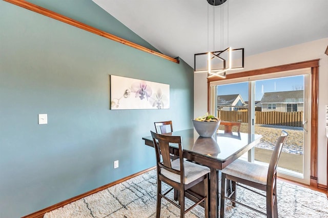 dining area featuring hardwood / wood-style flooring and lofted ceiling