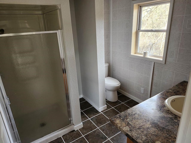 bathroom with vanity, tile walls, plenty of natural light, and tile patterned floors