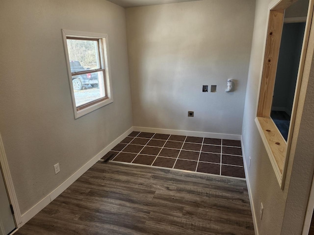 washroom with dark tile patterned floors and washer hookup