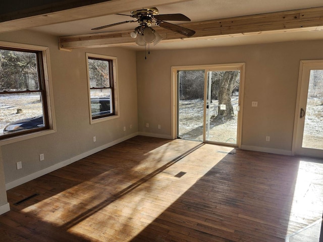 empty room featuring ceiling fan, dark hardwood / wood-style flooring, and beamed ceiling