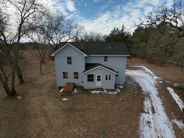 view of snow covered back of property