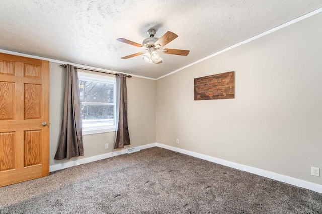 carpeted empty room with ceiling fan, vaulted ceiling, a textured ceiling, and ornamental molding