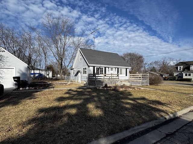 view of side of property with a deck and a lawn