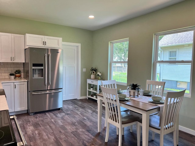 dining space featuring a wealth of natural light and dark hardwood / wood-style floors