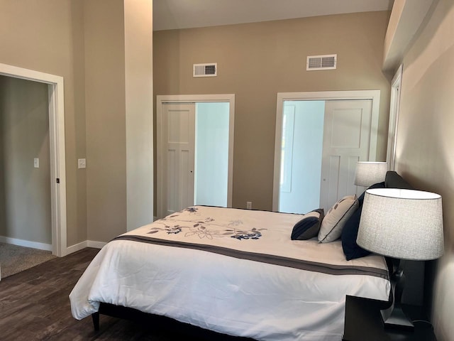 bedroom with dark wood-type flooring