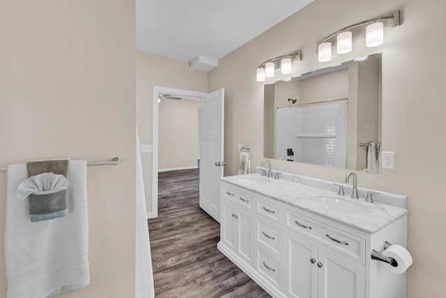 bathroom featuring vanity, hardwood / wood-style floors, and walk in shower