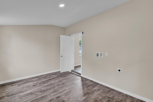 unfurnished room featuring hardwood / wood-style floors and vaulted ceiling