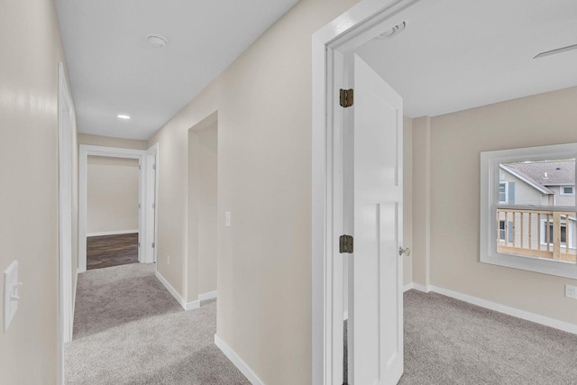 hallway with light colored carpet