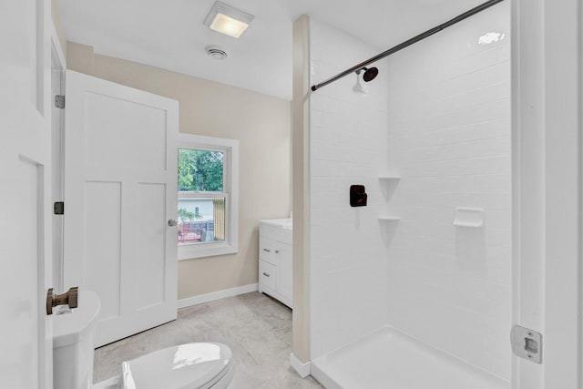 bathroom with walk in shower, vanity, and toilet