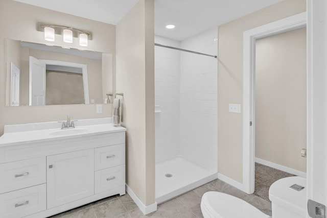 bathroom with toilet, vanity, tile patterned floors, and a tile shower