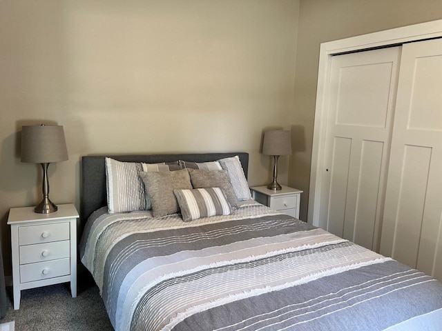 bedroom with a closet and dark colored carpet