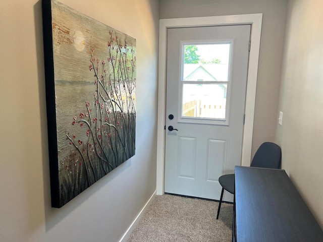 doorway with light colored carpet