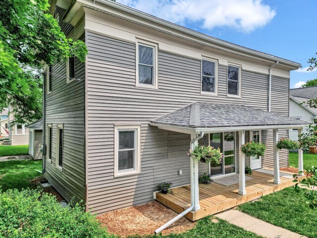 back of house with a wooden deck