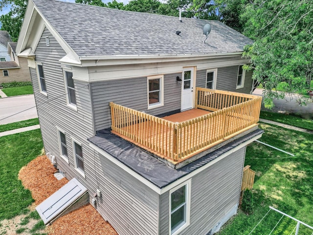 back of property featuring a yard and a balcony