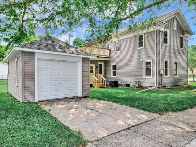 back of house with a lawn, a balcony, cooling unit, an outdoor structure, and a garage