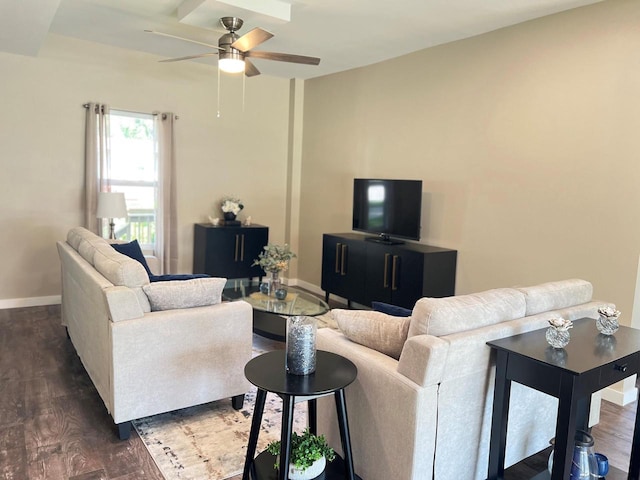 living room featuring dark wood-type flooring and ceiling fan