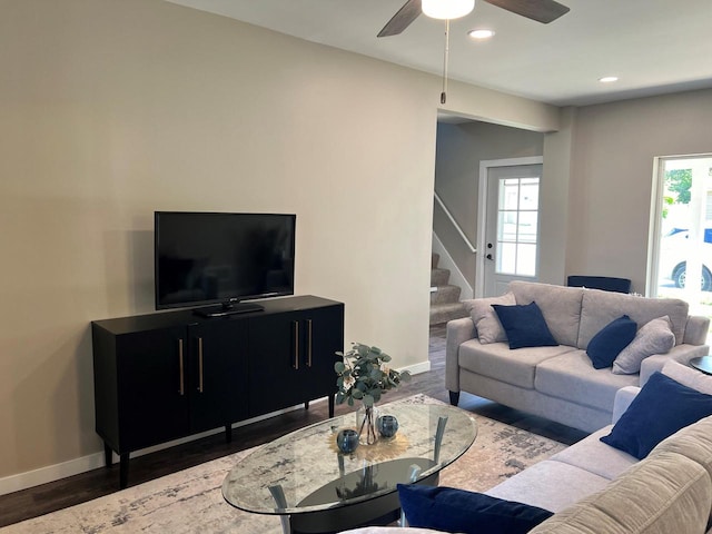 living room with ceiling fan and dark hardwood / wood-style floors